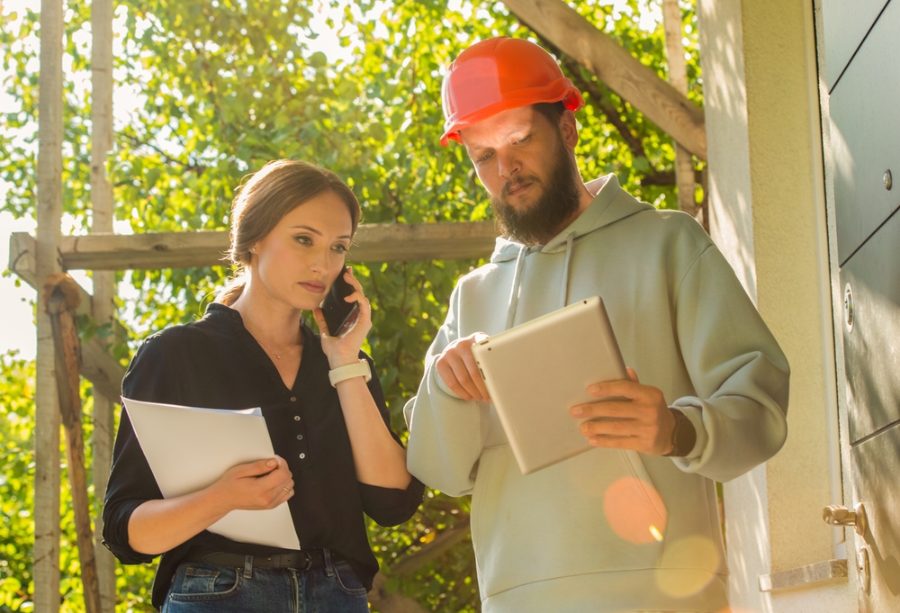 facilities management supervisor reviewing standards on a client site with a frontline team member