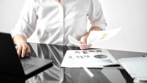 leader reviewing team performance notes at a desk reflecting on a difficult people decision