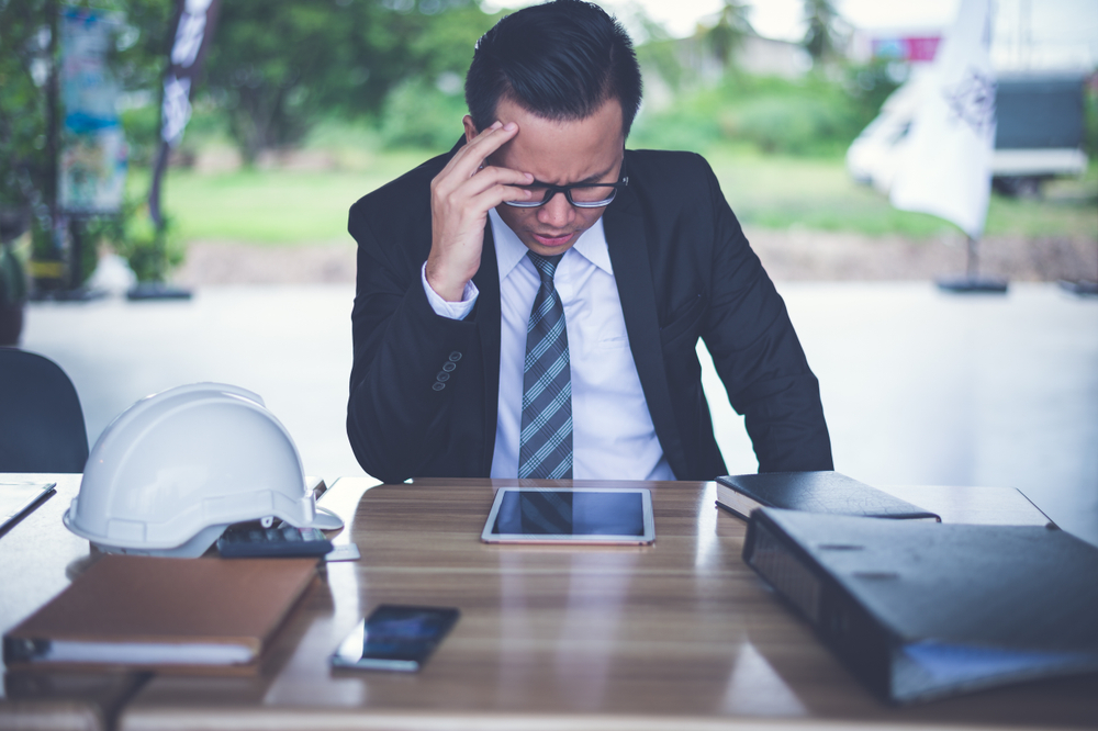 founder sitting alone at a desk reflecting on the weight of leading a team through personal difficulty