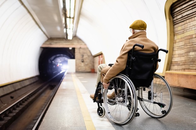 a wheelchair commuter at an underground train station