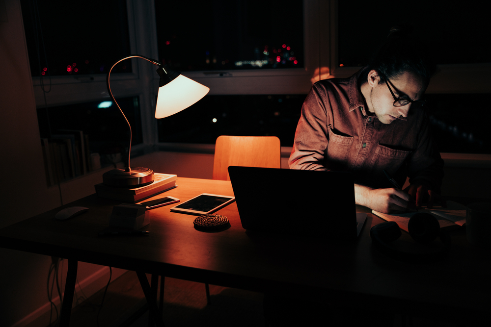 business founder working alone late at night after making a difficult decision
