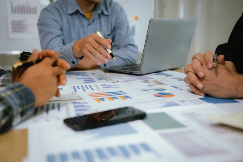 Founder reviewing business growth metrics and systems at a desk